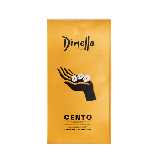 A package of Dimello Cento espresso coffee beans with a graphic of a hand holding coffee beans on a yellow background.